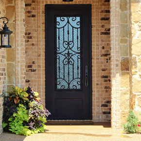 Picture of a dark colored front door on a light colored brick home. Door has a almost full glass insert.